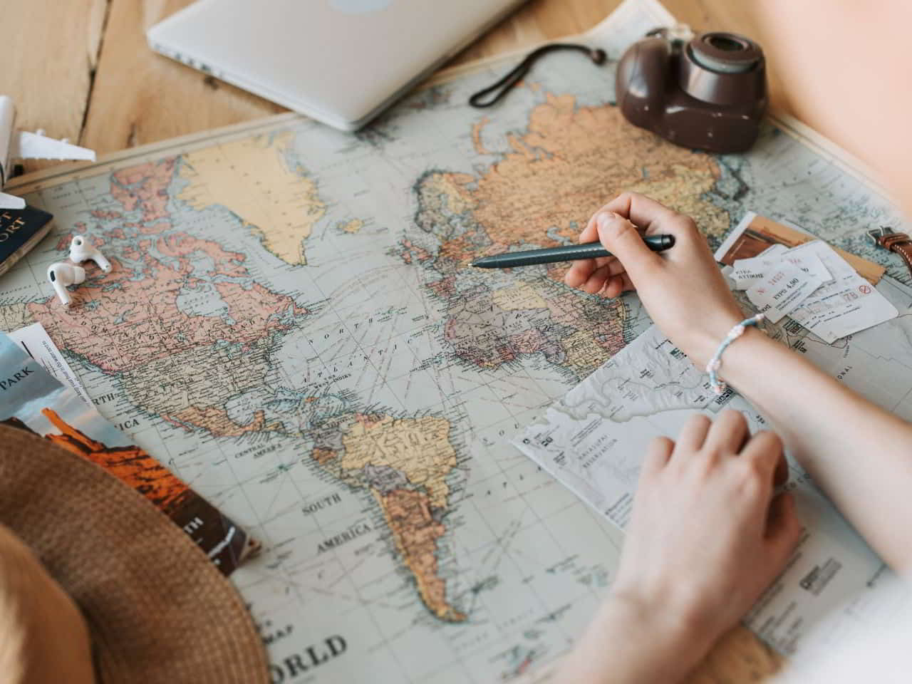 A girl noting down her route on world map for traveling