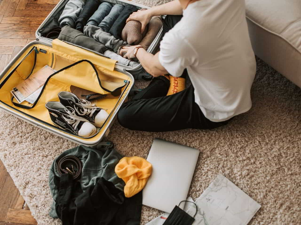 A boy packing his traveling bag