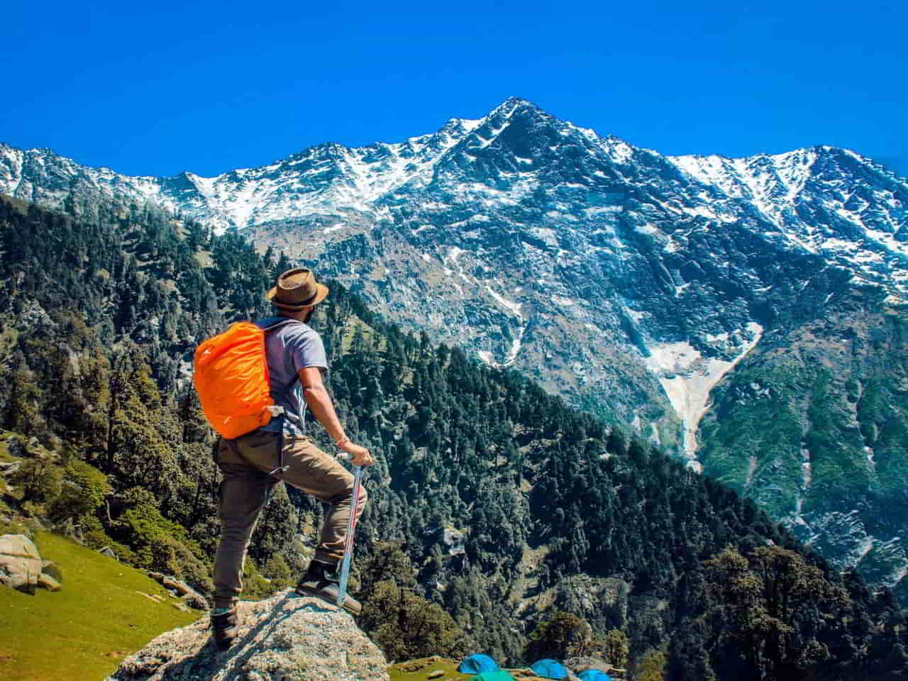 a guy is looking at the mountains