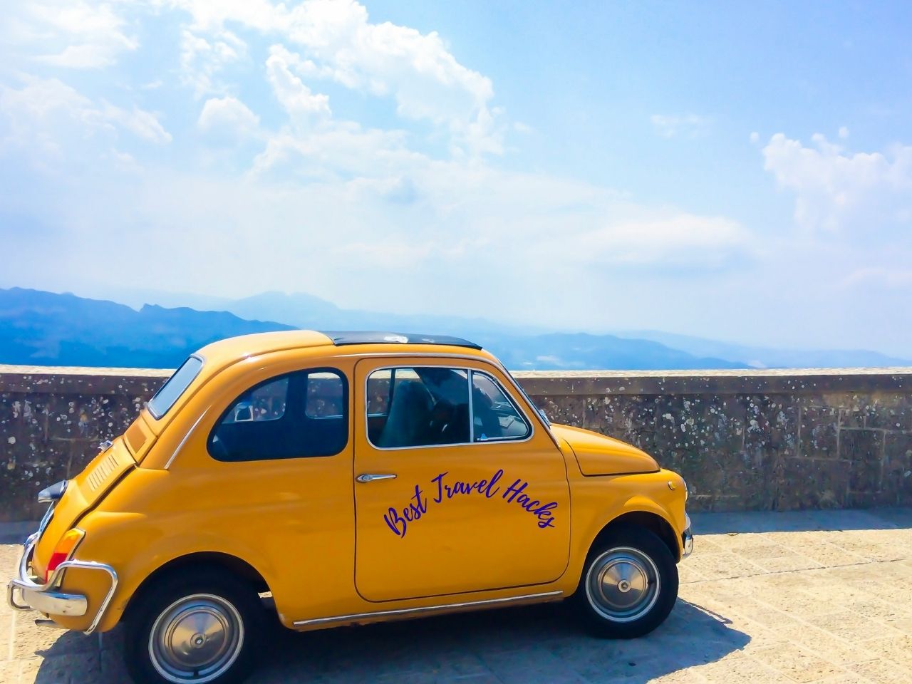 A yellow car showing best travel hacks written on it