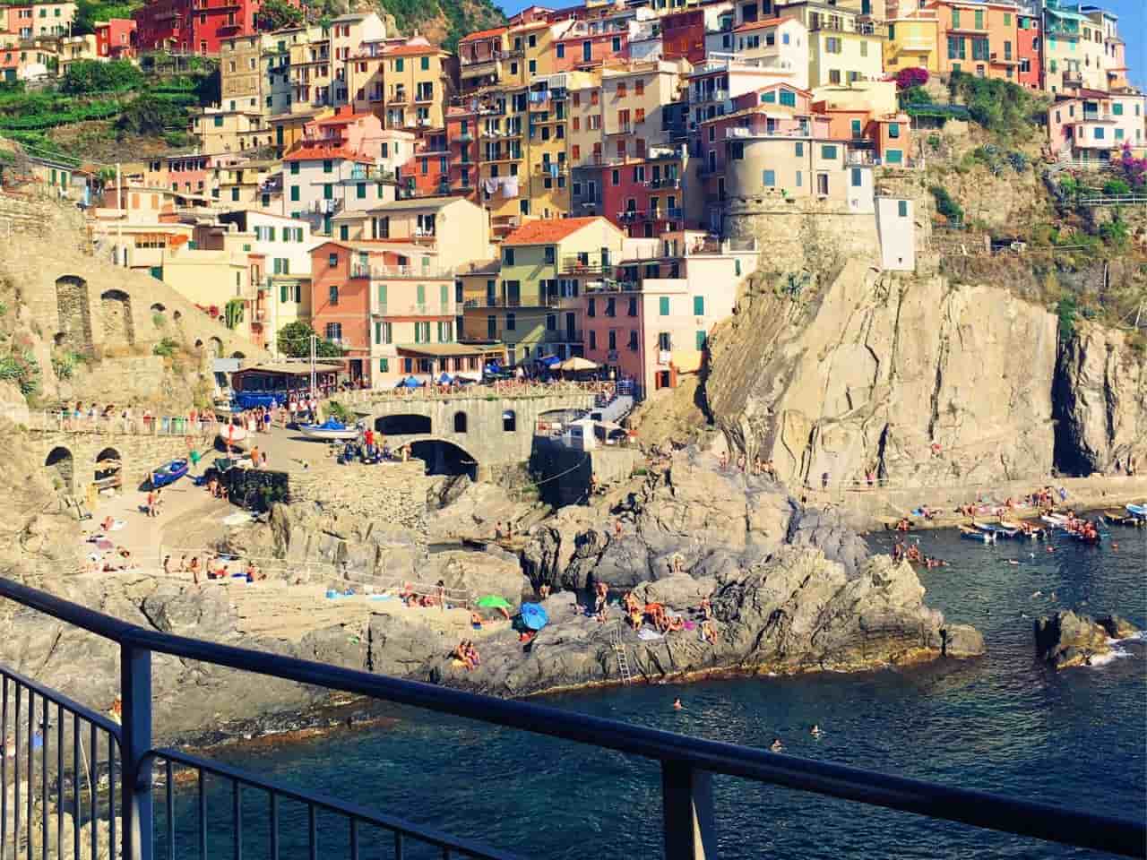 People cliff diving in Vernazza Cinque Terre Italy