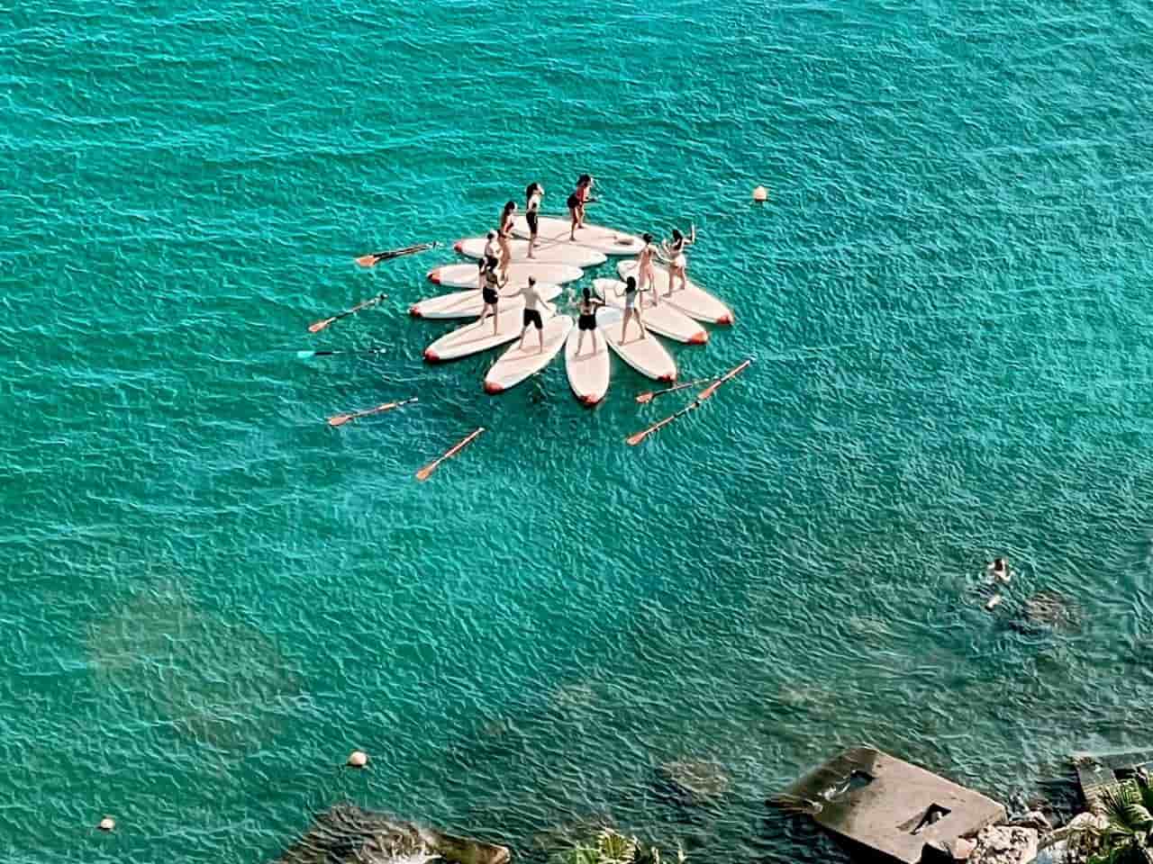 Youth doing Stand Up Paddleboarding in Cinque Terre Italy