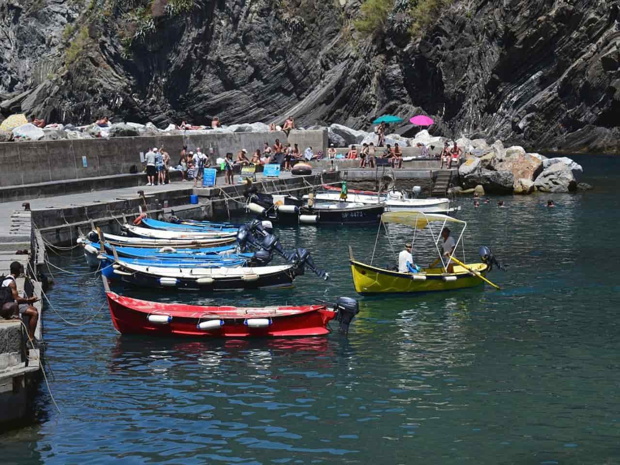 People embarking for a night boat tour in Cinque Terre Italy