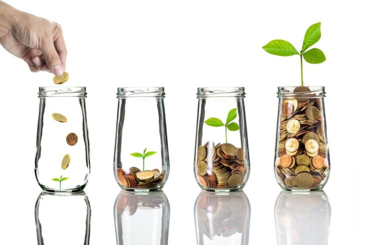 4 glass jar having tiny plants and coins to make you understand money hacks to live debt-free life