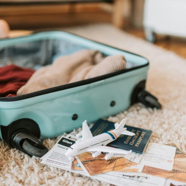 a travel bag and passport read this guide to avoid common packing mistakes