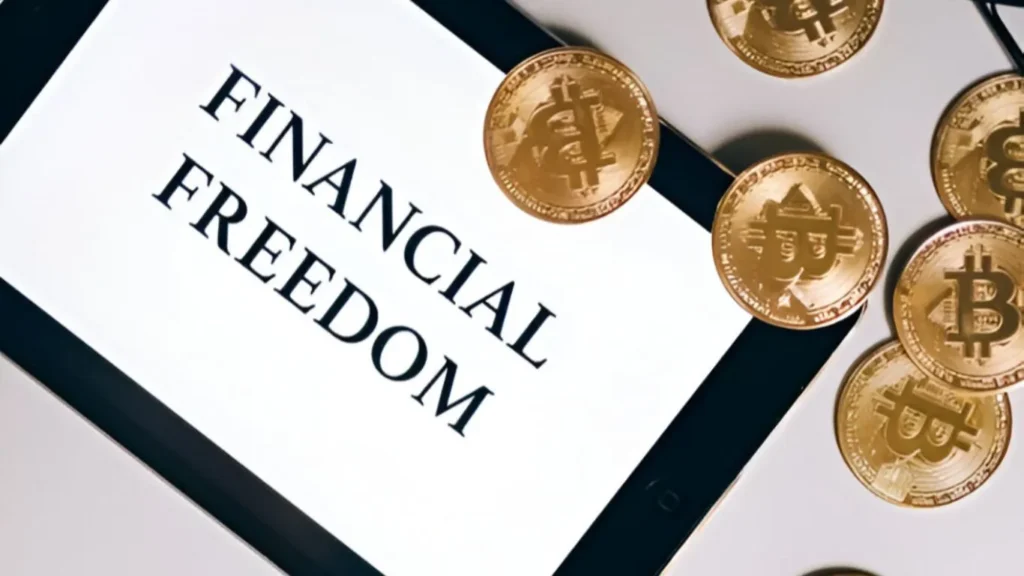 A tablet having written "Financial Freedom" words in bold capital letters along with some currency coins describes the image as how to achieve financial freedom