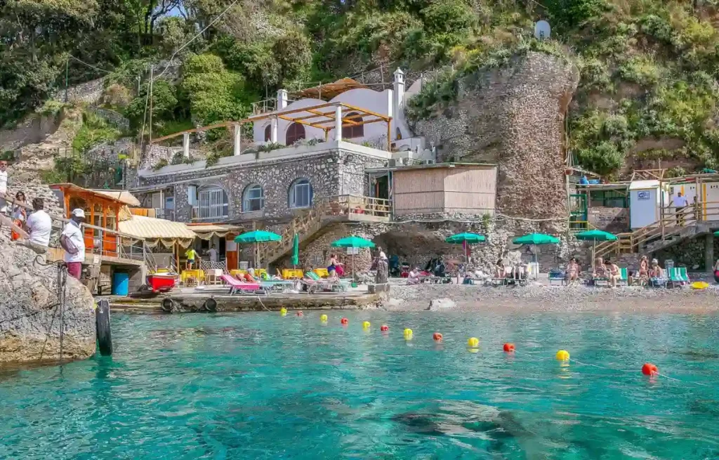 People relaxing on Capri’s northern coastline, Bagni di Tiberio the best thing to do while you're in Capri