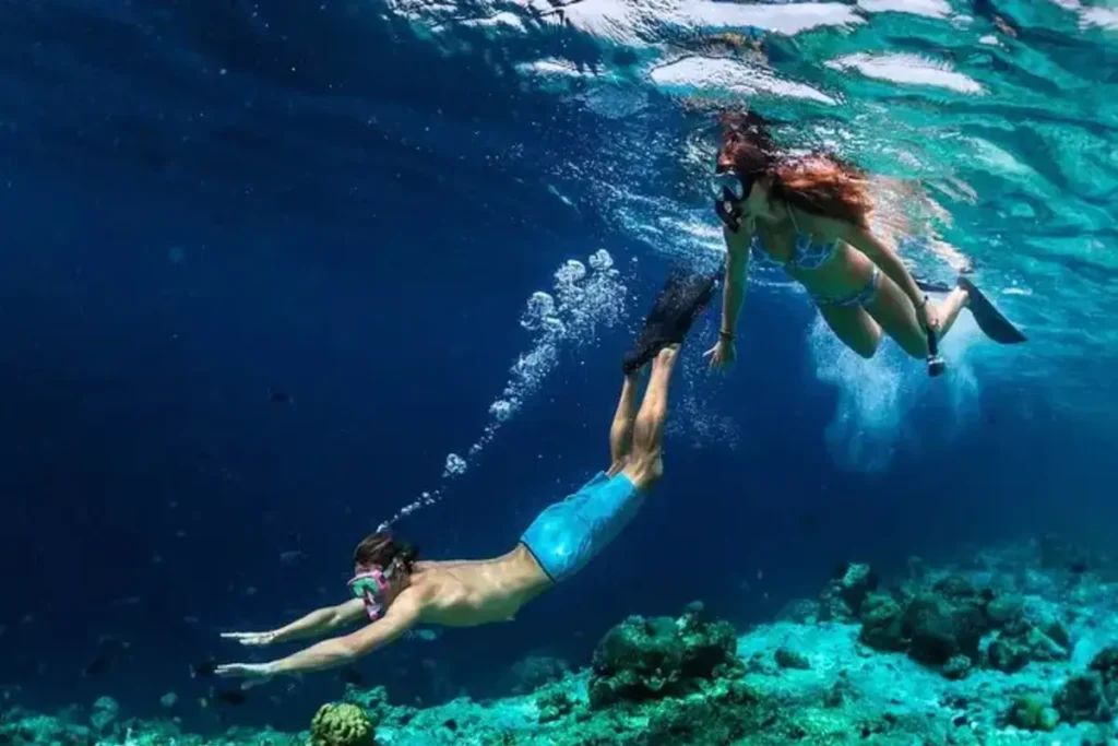 Divers are in the water doing snorkeling as one of the best things to do in capri