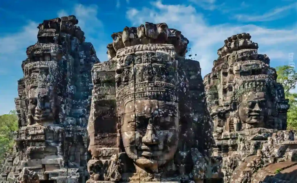 Iconic faces carved on the rock in Cambodia; the country to travel on a budget to list in your diary for Cheapest countries to visit