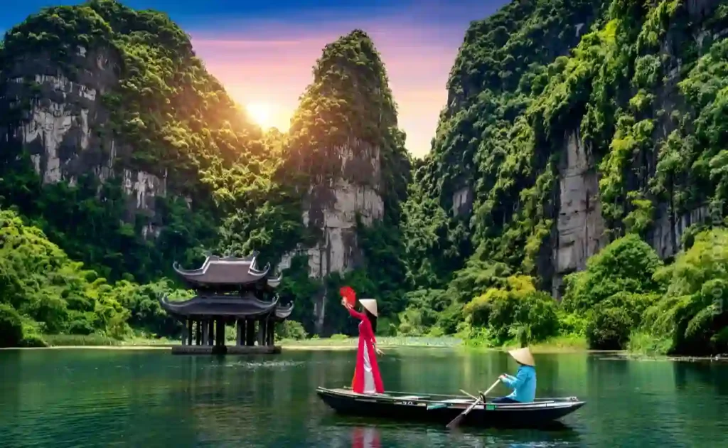 a lady and a boat rider riding his boat on a rive in one of the cheapest countries to visit in the world; Vietnam