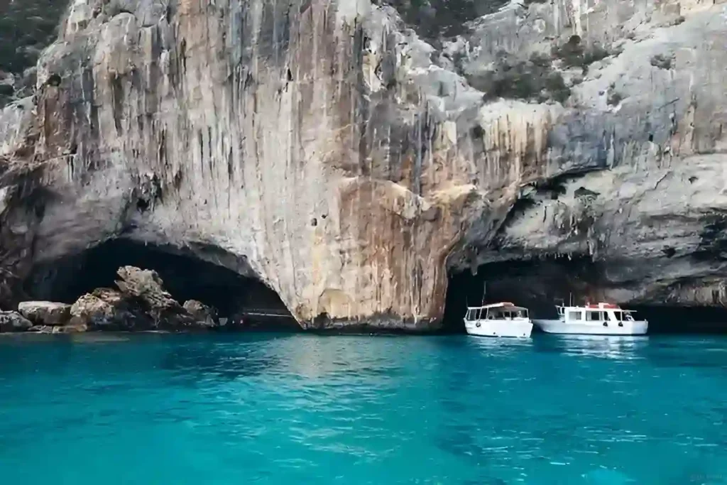 Amazing blue water and two white boats standing in Cala Luna Beach which is one of the Best Beaches in Sardinia,Italy
