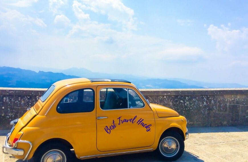 A yellow car showing best travel hacks written on it