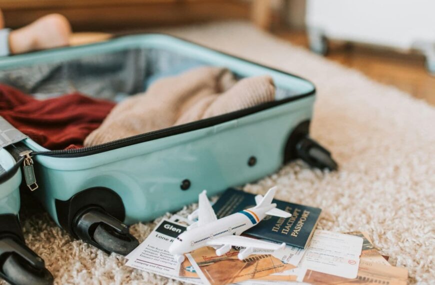 a travel bag and passport read this guide to avoid common packing mistakes