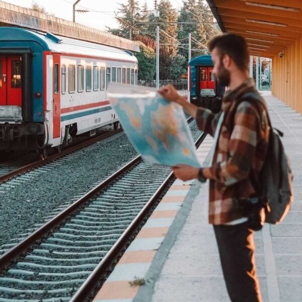 Traveler Checking a map in a European train station and recalling Europe Travel Tips