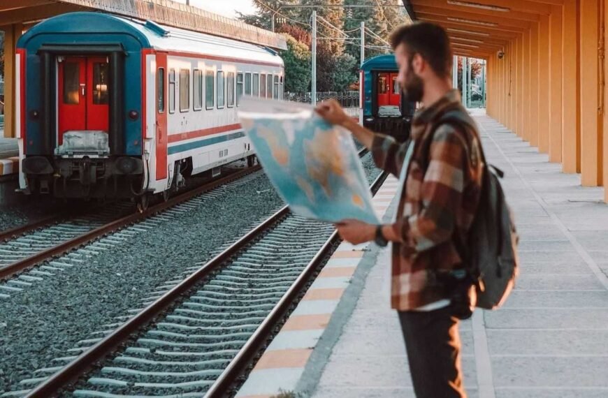 Traveler Checking a map in a European train station and recalling Europe Travel Tips