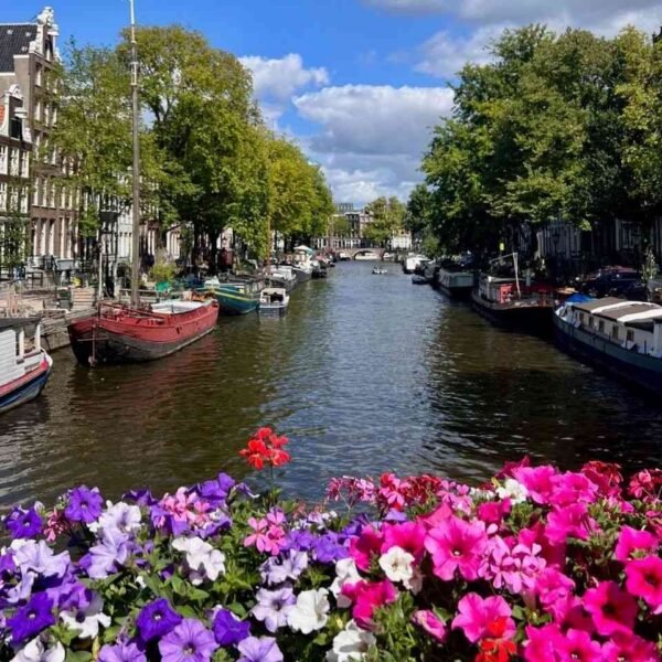 Spring canal-side street in Amsterdam, the best time to visit Europe