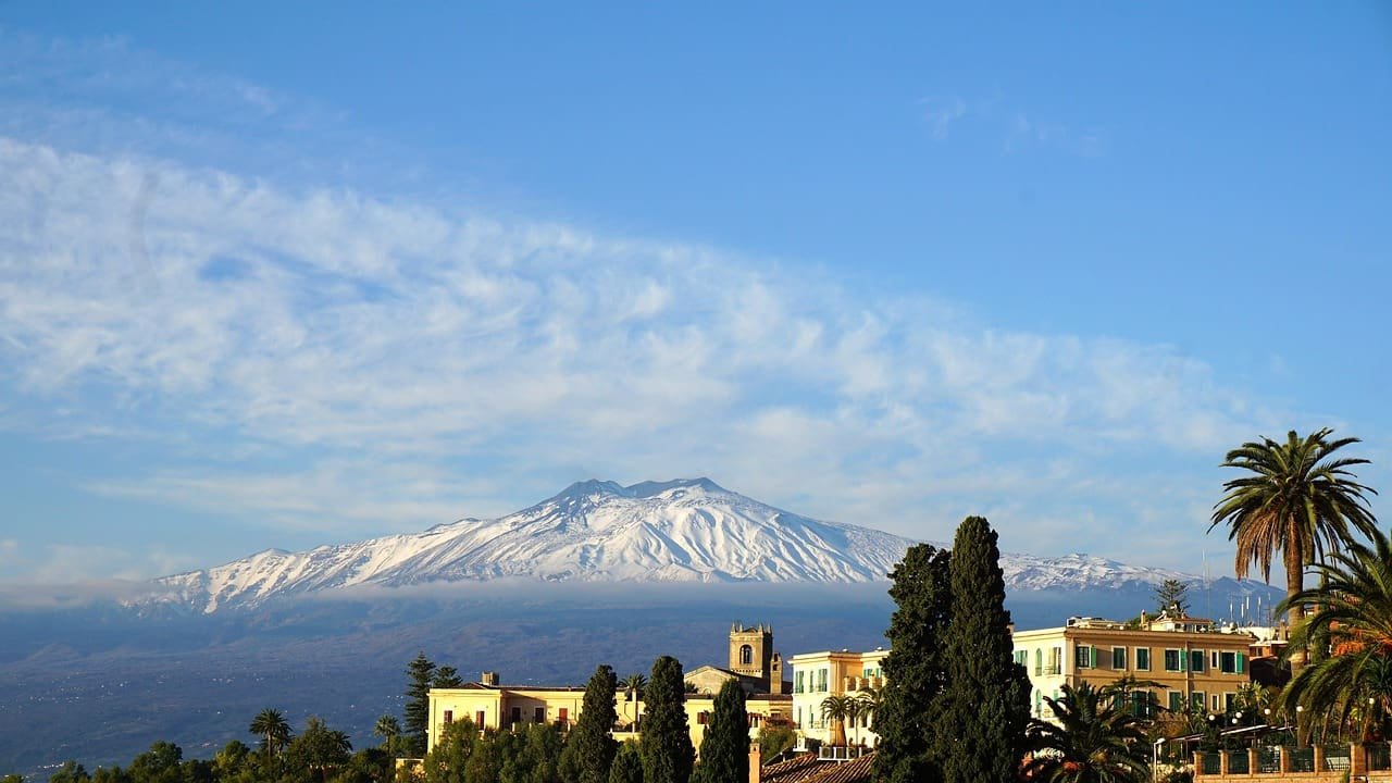 Mount Etna, towering over the coastal landscape of Sicily, Italy