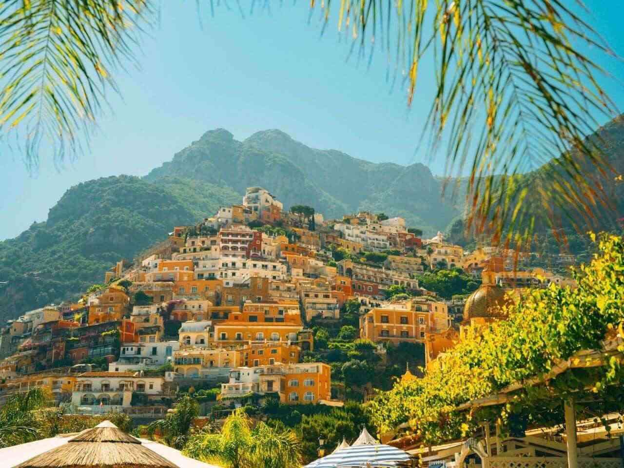 Pastel-colored houses stacked on the hillside in Positano Italy