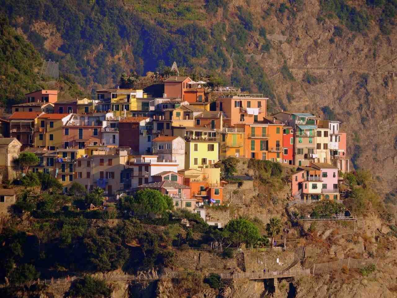 Colorful houses perched on a cliff in Corniglia Cinque Terre Italy
