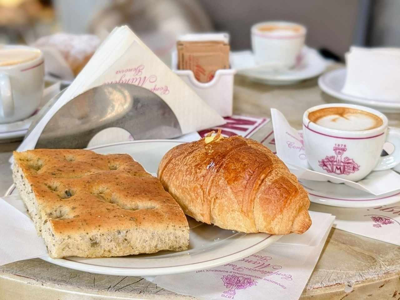 traditional Italian breakfast with focaccia and croissant